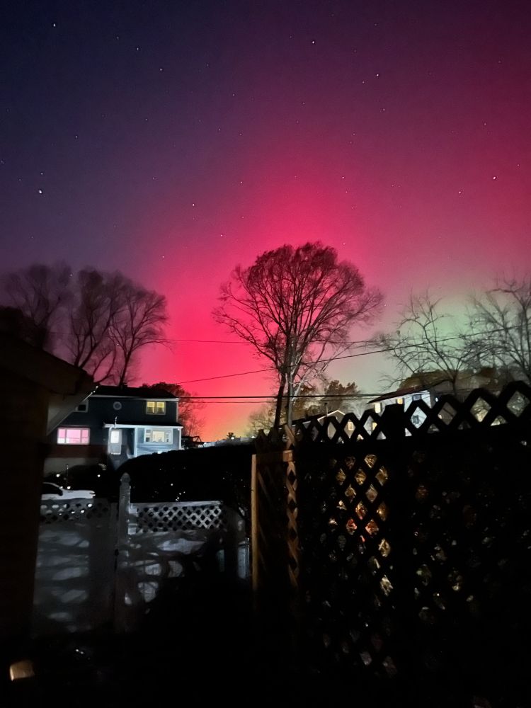 Northern lights over houses.