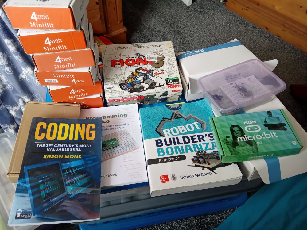 Some MiniBit robots, a couple of potential robot projects, 3 books some Pi Pico bits, and 2 Microbit kits, all of which are staying out in the open, much to the disappointment of my wife 😬