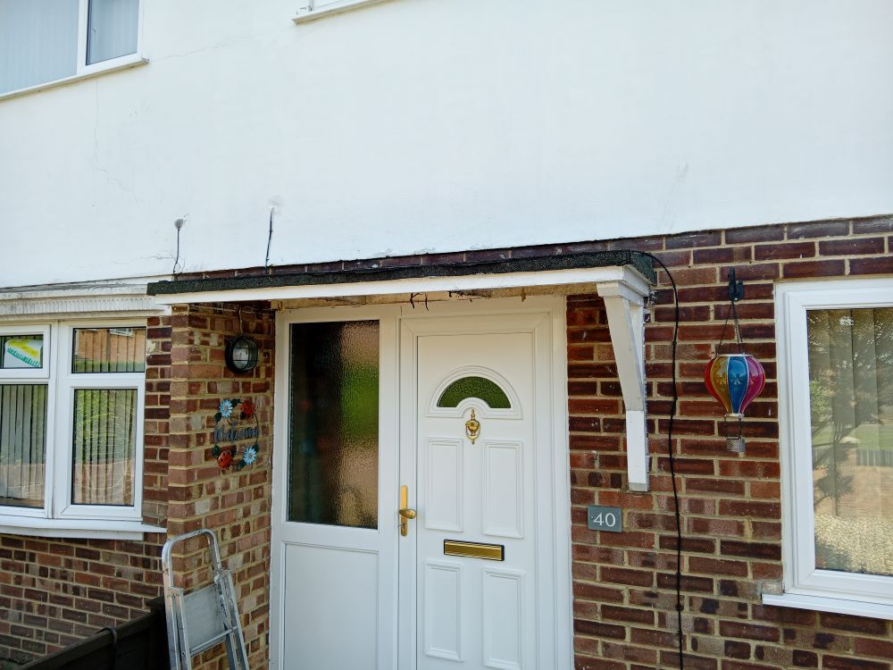 A boring, felt-covered porch that is well past it's sell-by-date. It was put up when the house was built in 72. 