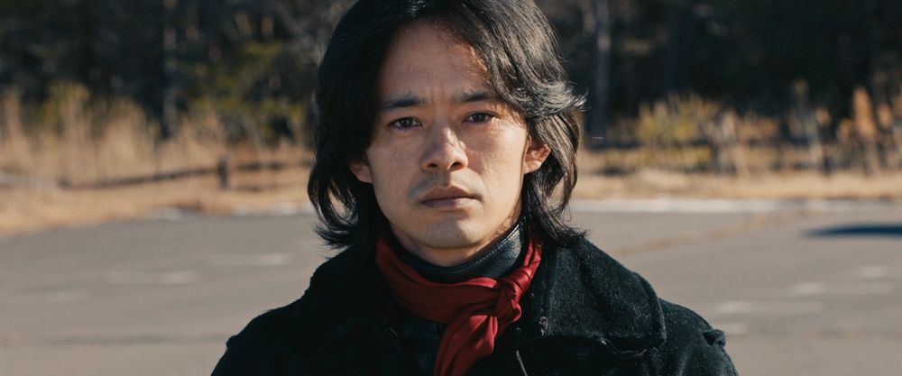 Hongo Takeshi from Shin Kamen Rider at a field facing the audience.