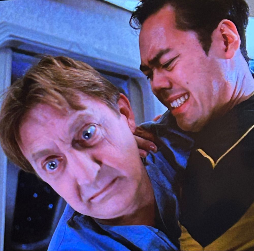 two star trek characters locked in some sort of peculiar embrace 