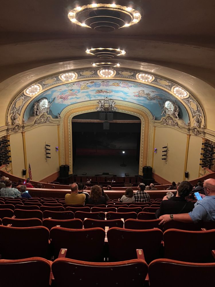 Picture of the theater from the back row. Most of the chairs were empty implying it was taken early. There is a dome ceiling on which there is plasterwork and mural work that took some serious mastery.