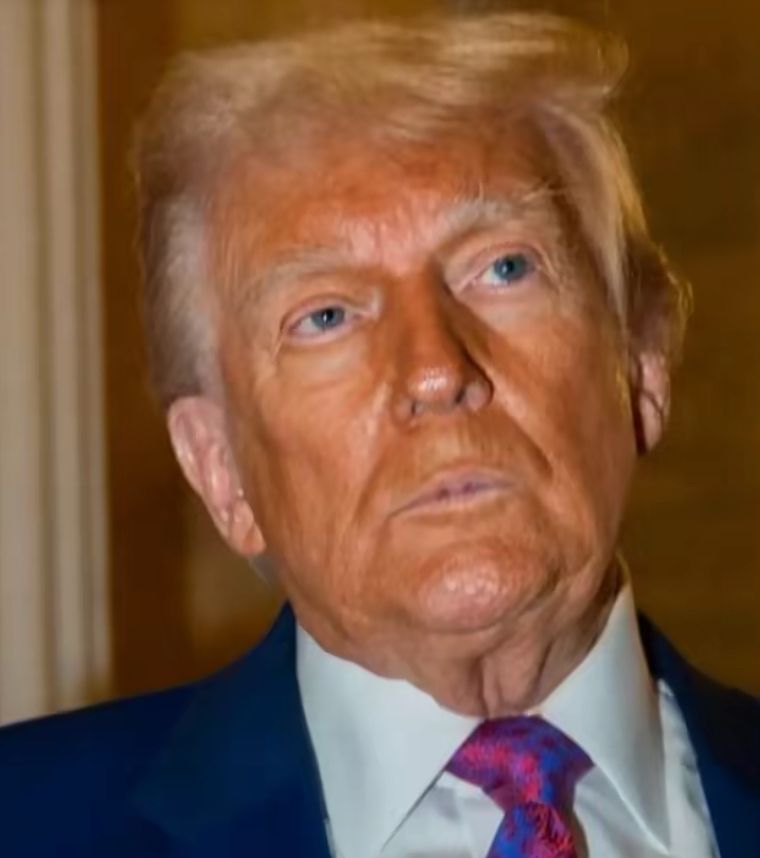 A decaying carcass painted orange with a roller brush. 