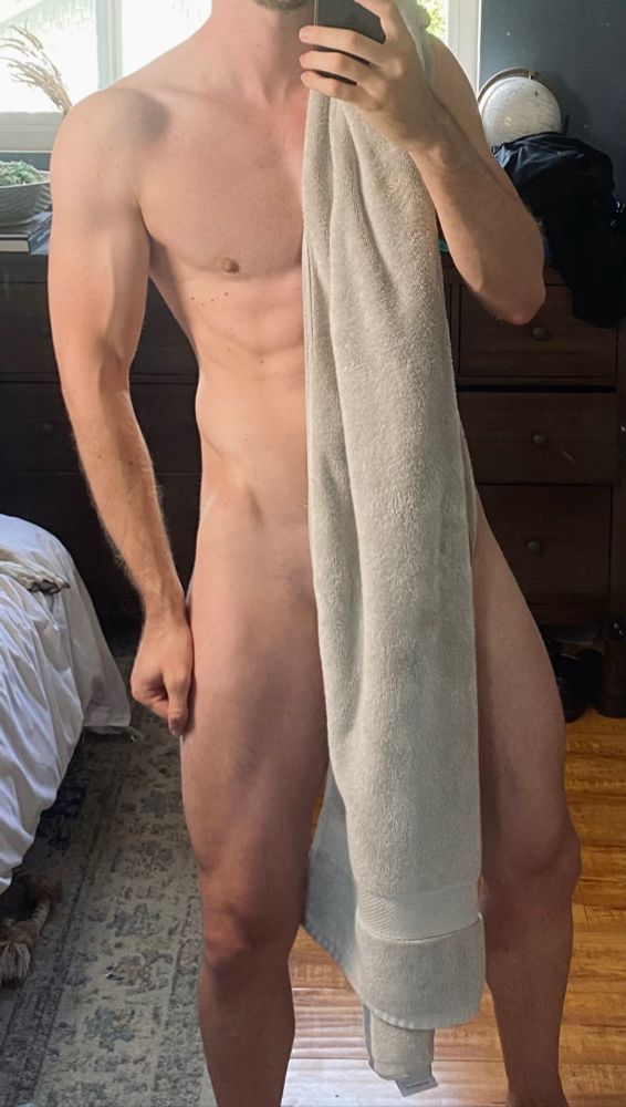 A naked, athletic male body wearing a strategically placed towel.