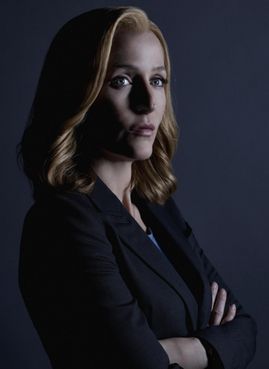 Dana Scully with her arms crossed shot in profile.