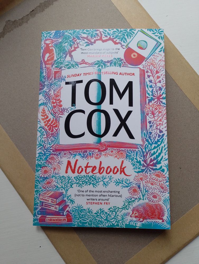 Notebook by Tom Cox. A wonderful illustration on the front cover in, blues, greens and reds of wildlife, foliage, vinyl records and books.