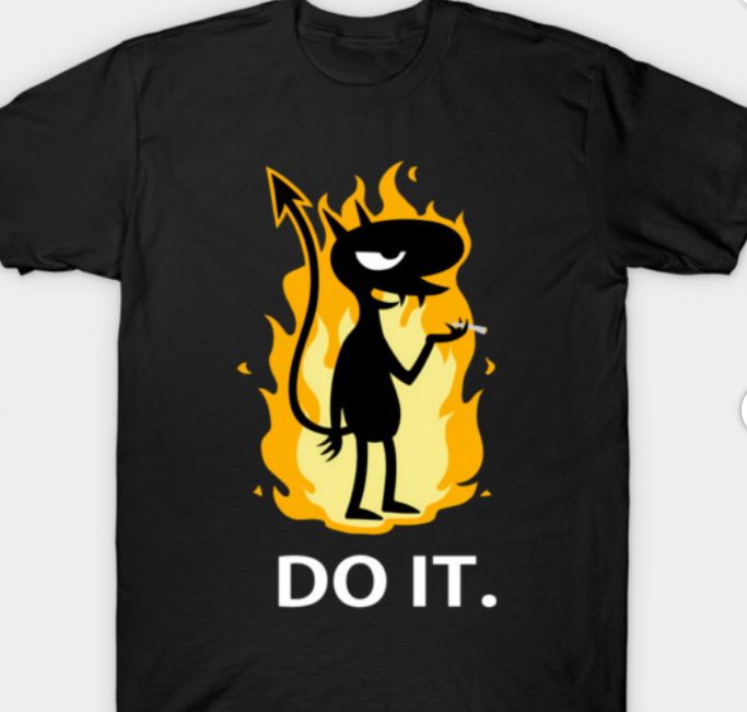 A black t-shirt with a depiction of Luci from the cartoon series Disenchanted, holding a cigarette, against a backdrop of flames. Underneath this it says Do It.