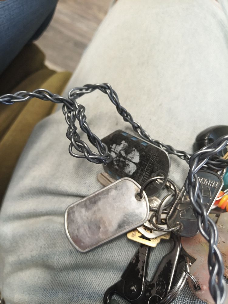 Cod ghosts dog tag keychain next to a blank one 