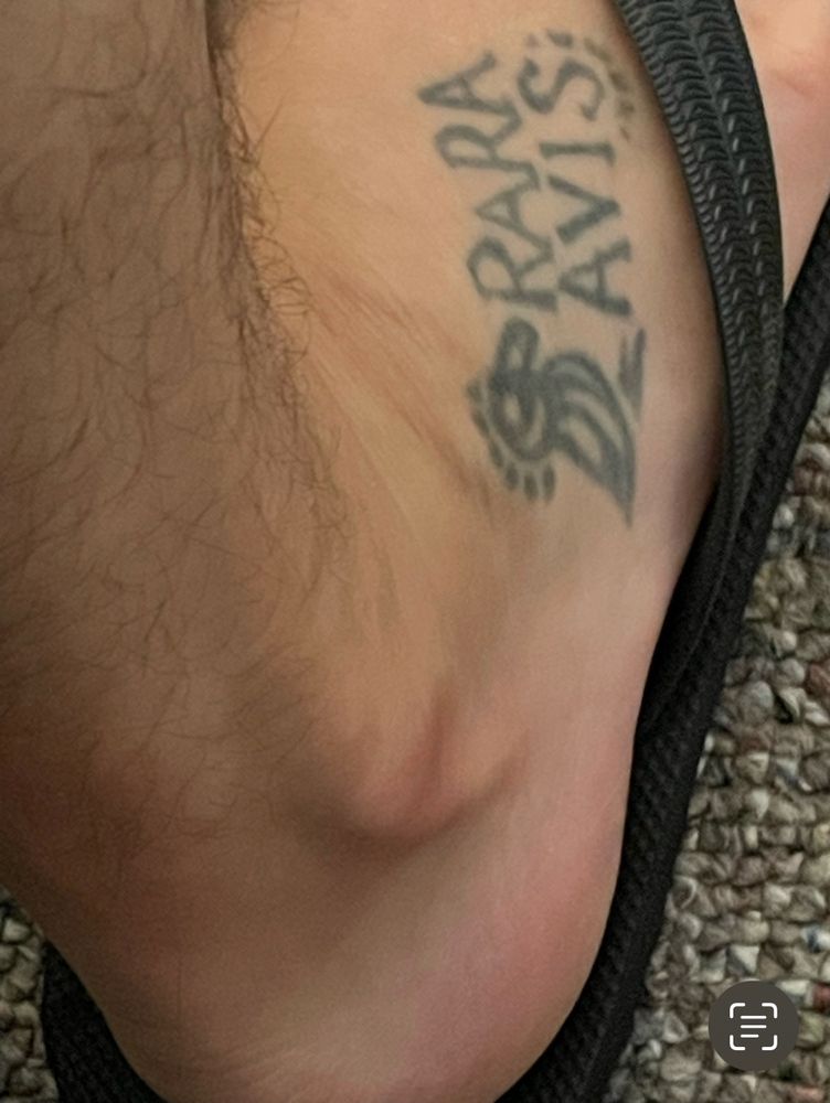 Tattoo on Jody’s foot with bird saying Rara Avis
