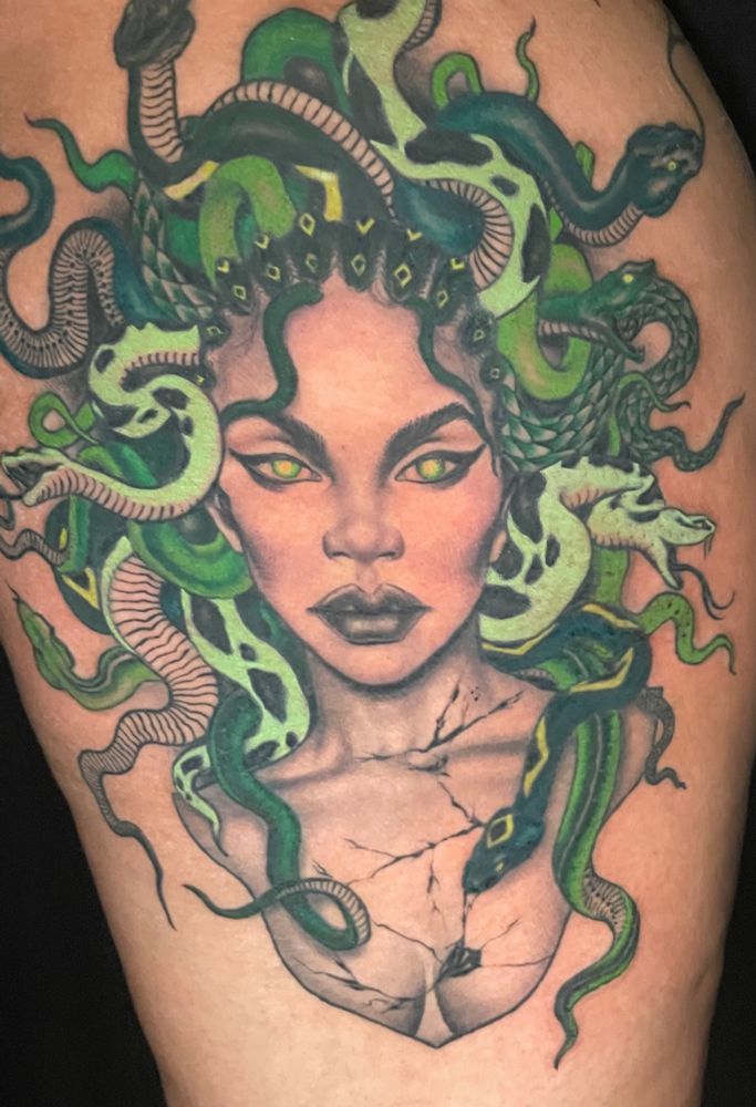 Up close photo of a Medusa tattoo on the upper thigh. 