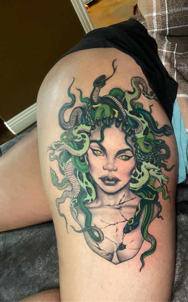 Photo of a Medusa tattoo on the upper thigh. 