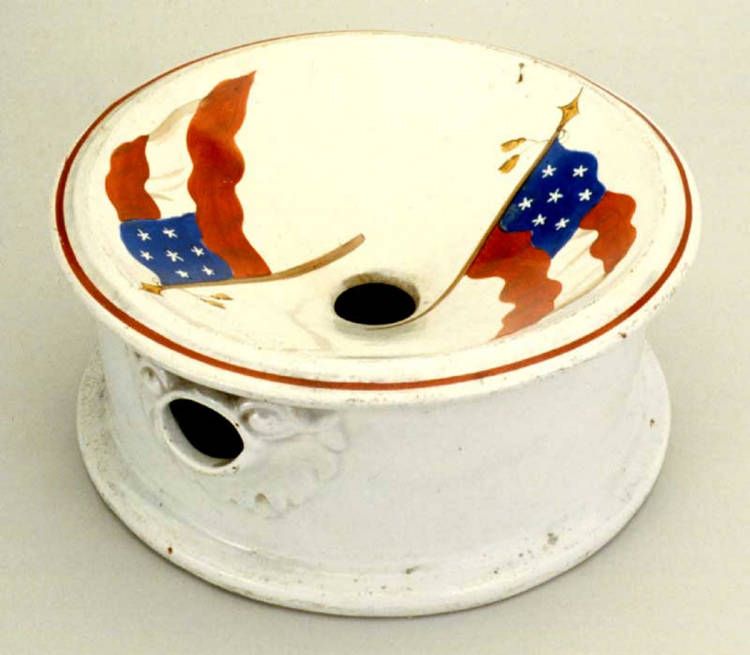A ceramic spittoon with two flags