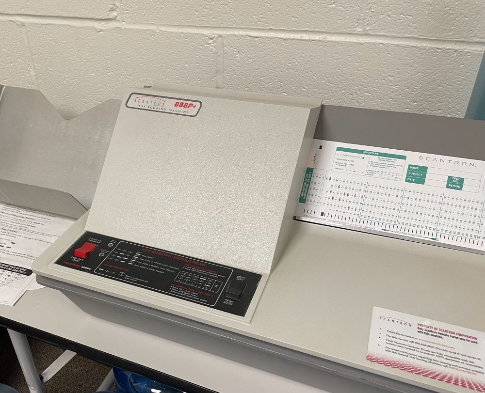 A very old gray and black scantron machine