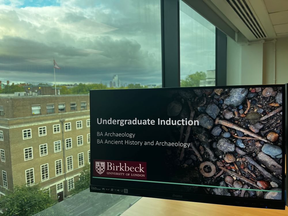 Screen showing archaeology of the Thames for our BA archaeology programmes at Birkbeck. It’s a clear evening outside the window with a great view of the London skyline.