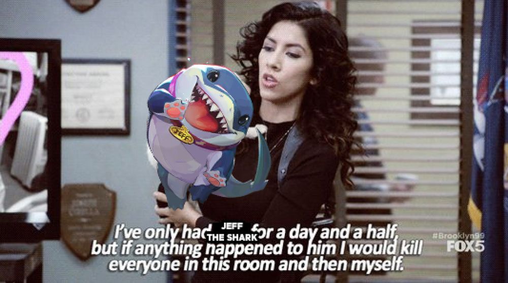 an edited screenshot from the television sitcom 'Brooklyn Nine-Nine', where Detective Santiago is seen holding a photoshopped image of the Marvel Rivals character Jeff the Shark and saying the words 'I've only had Jeff the Shark for a day and a half, but if anything happened to him I would kill everyone in this room and then myself' 