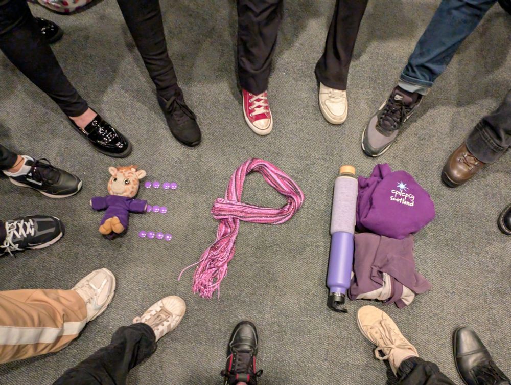 The letters EPB have been made from purple items with shoes pointing inwards