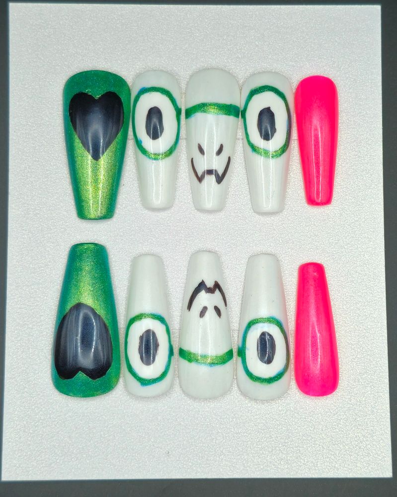 Ralsei's nail set, pink and green to represent his outfit, and centered around a drawing of him smiling sweetly, a la his plush form from Chapter 3