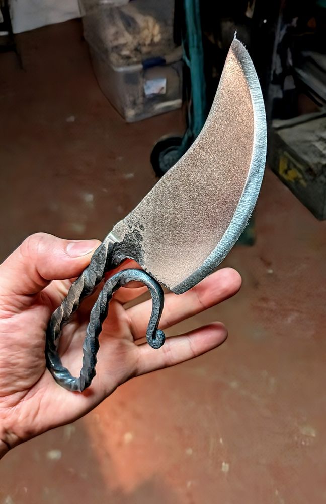 A blacksmiths knife with a curled handle 