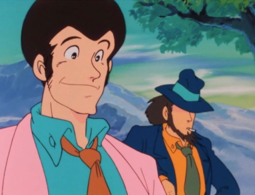 Two handsome men. The one in front is wearing a pink jacket and has stylish sideburns. The one in back is wearing a dark blue suit and hat, and is smoking a cigarette.