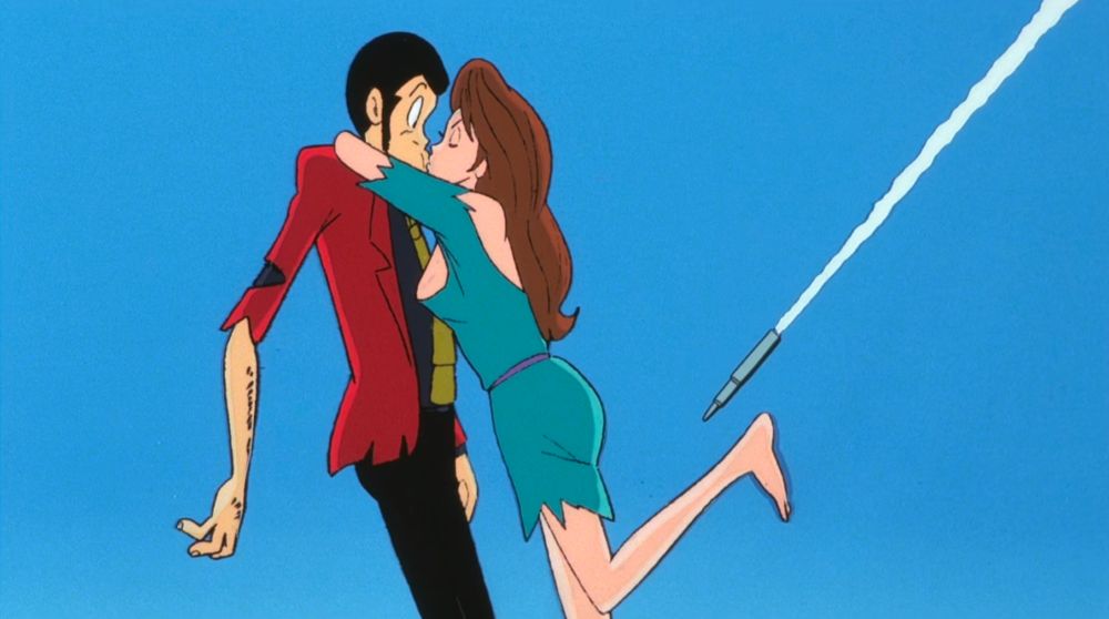 The kiss continues. A missile is visible in the background.