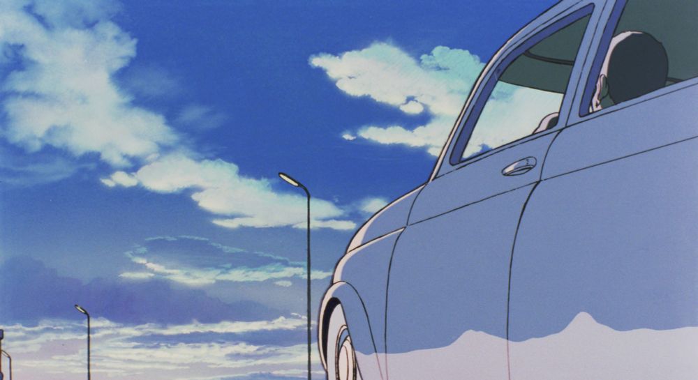 A handsome man visible through the driver's side of a Fiat 500