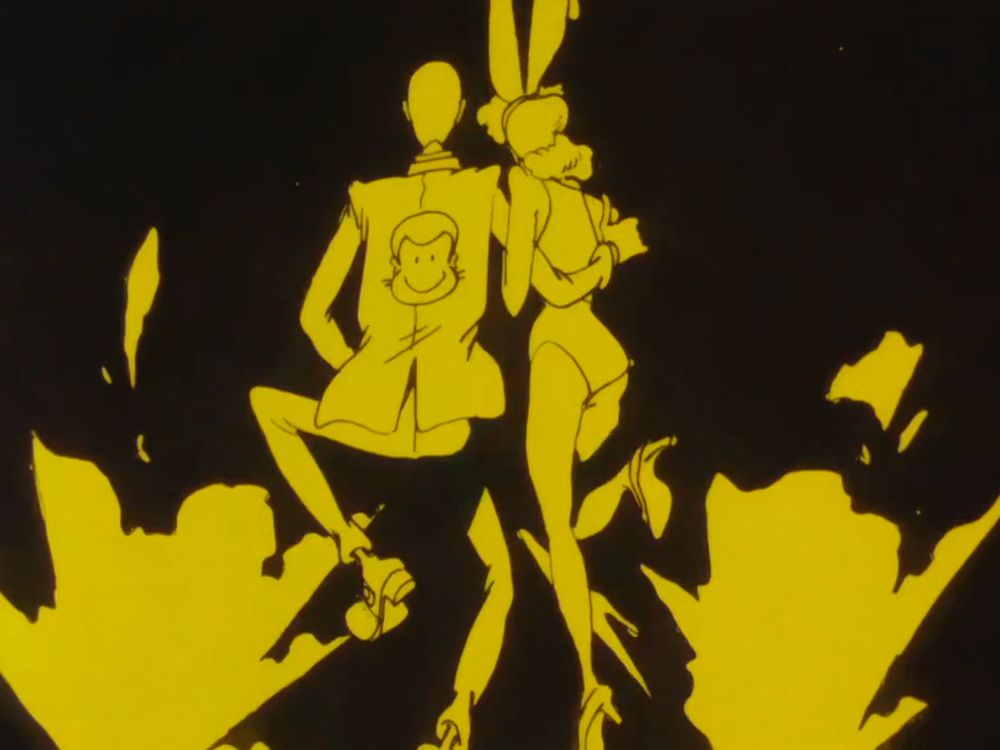 An extremely handsome man with his arm around a beautiful lady in a bunny costume. The handsome man has a caricature of himself on the back of his jacket.