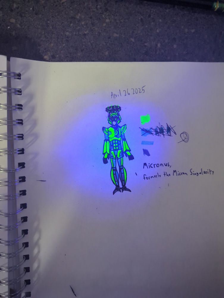 Text ID: April 26, 2025
Micronus, formerly the Micron Singularity
Image Description: Micronus, a green Nd blue robot with a grey halo. Half of their chest is open, exposing internal detailing. This version of the image is lit using a blacklight so the green parts fluoresce.
