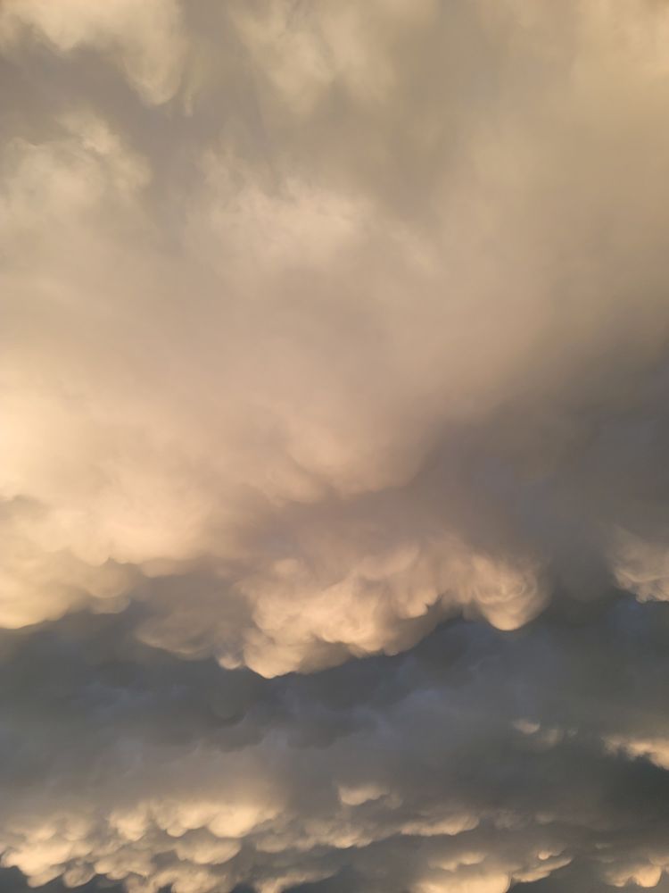 Layers of clouds that get darker near the bottom with hints of blue visible near the bottom half.