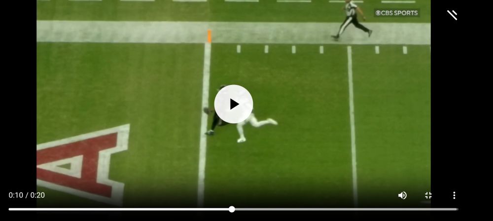 Side view of the ball in Demercado's hand with the ball over the goal line