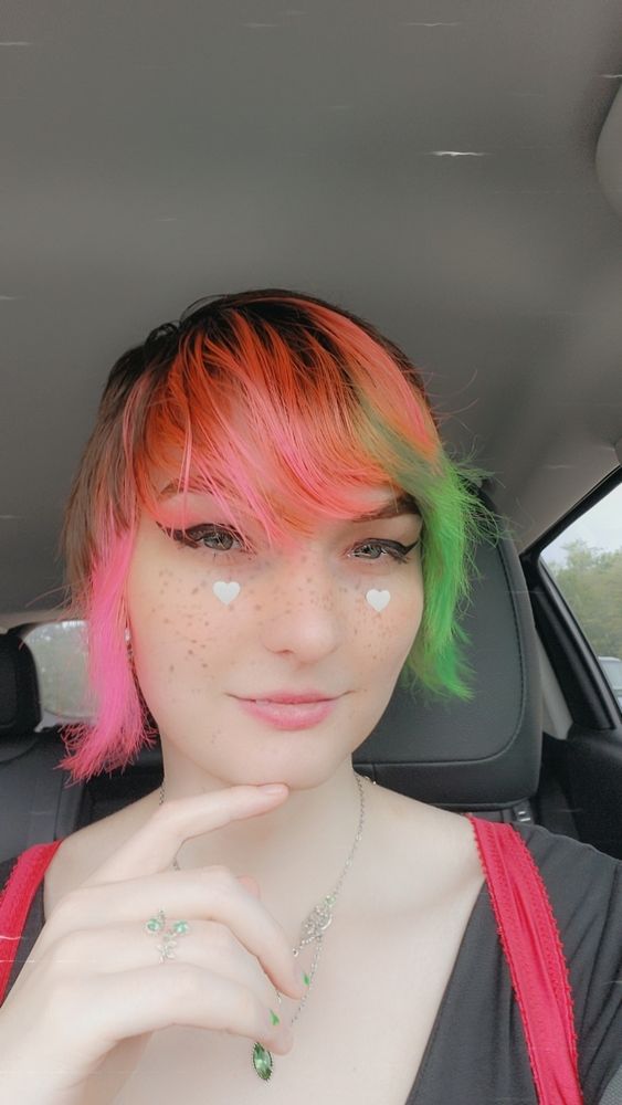 An old selfie of me with pink and green hair and a lil smile 
