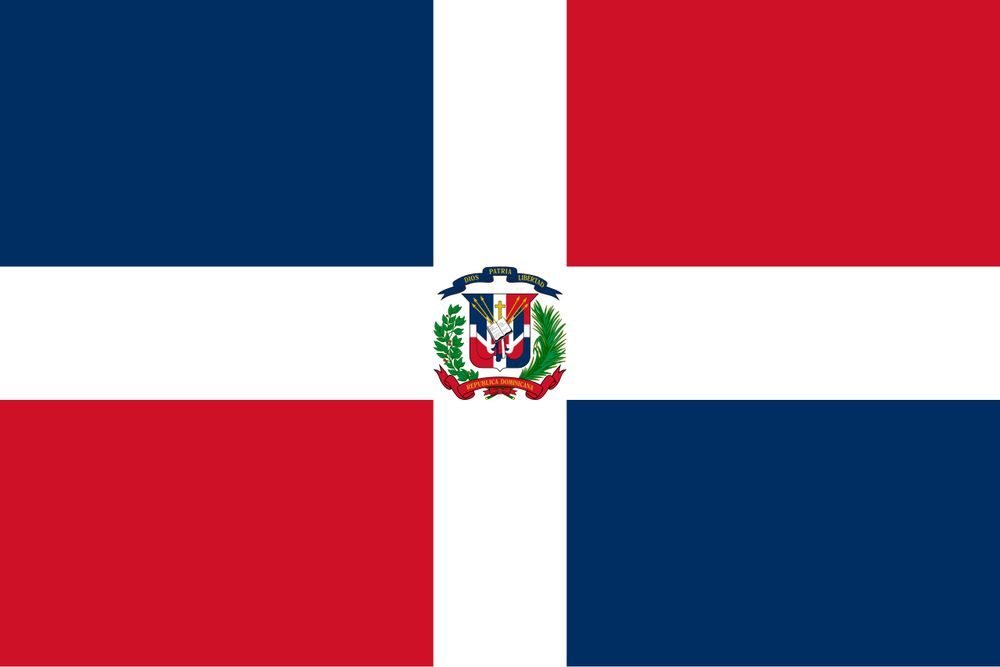 dominican republic flag. it has four quadrants that are blue, red, blue, red in clockwise direction starting on the top left. a white cross goes in between separating all quadrants. in the center there is a crest of arms that would be too complex to explain in detail, but it includes plants, spears, smaller copies of the flag, ribbons with different messages and an open bible. 