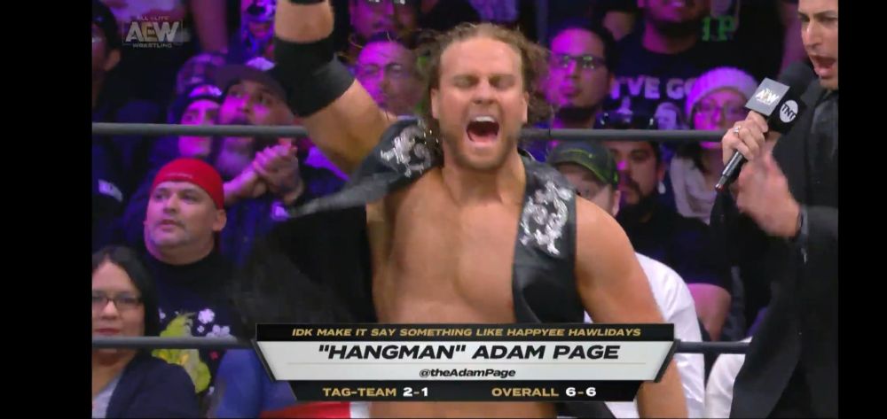 A pic of Adam Page's chyron that says "IDK make it say something like Happyee Hawlidays"