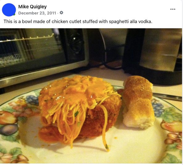 a plate with spaghetti alla vodka inside a bowl made of chicken cutlet, and a piece of bread