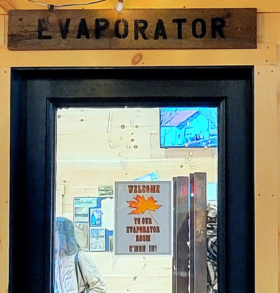 Sign on glass door reads WELCOME TO OUR EVAPORATOR ROOM. C'MON IN!