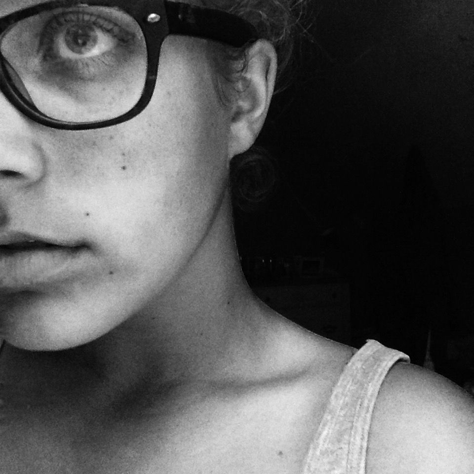 moody ass black and white half face selfie of grace. they have dark framed wayfarer style glasses on (prescription, tumblrcore) looking off to the left with lips parted. wearing a tank top (i probably had a flannel on top of it before this)

this bitch had nooooooo idea how gay they were lmaoooooooooooooo fuck