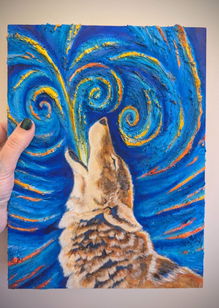 Hand holding a small acrylic painting of a coyote howling with an abstract background of yellow and red swirls on waves of blue. The background is heavily textured. 