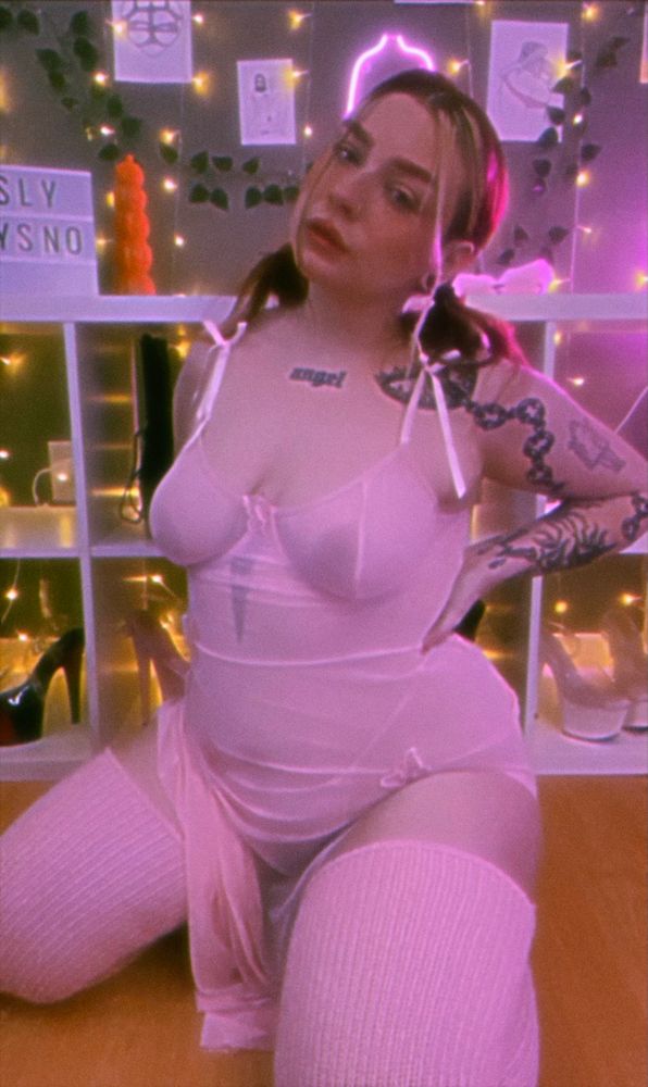 Sno in the same outfit as mentioned in previous photos. Her hands are on her waist. Her nipples can be seen through the sheer night gown