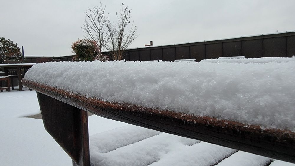 Snowfall on Adirondack chair