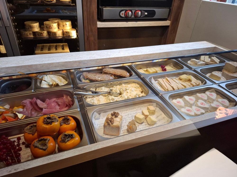 Buffet trays holding sweets, cakes, and persimmons