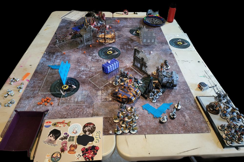 Tabletop showing a 40k between space wolves and drukari