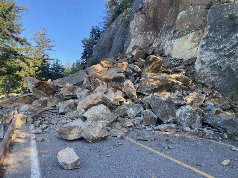 Rockslide with man standing to the outer left.