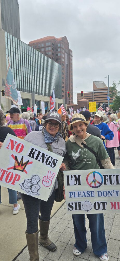 I'm peaceful, please don't shoot me sign. No kings, stop ice sign.