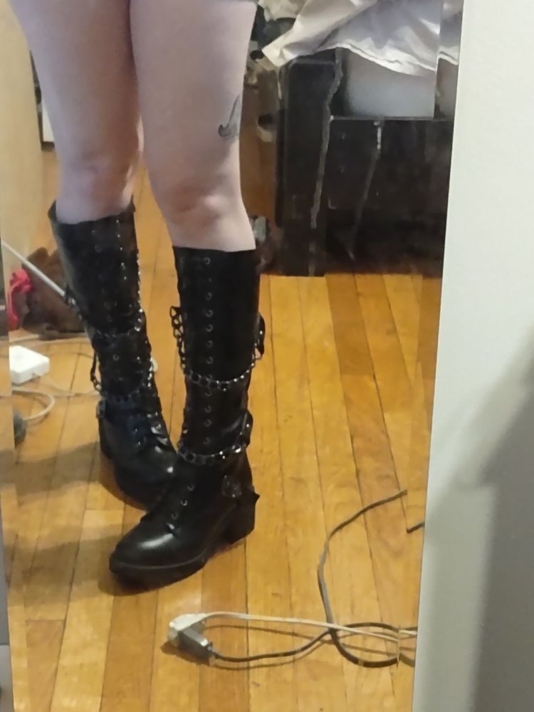 Awesome black pleather boots with a couple of cool kid chains on em. On lain's legs.