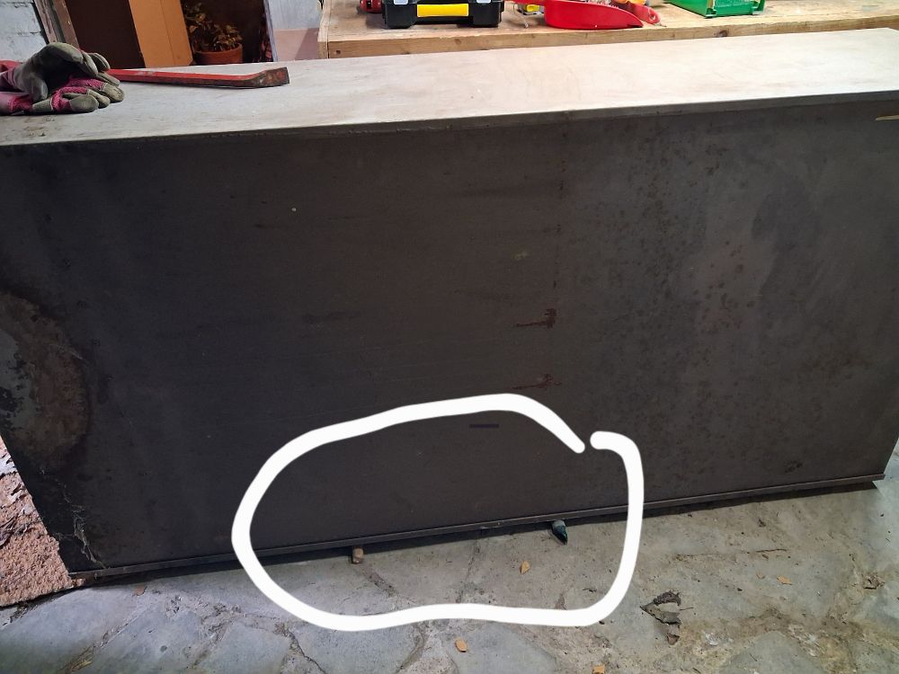 A prostrate metal filing cabinet resting on two small but mighty wooden rollers.