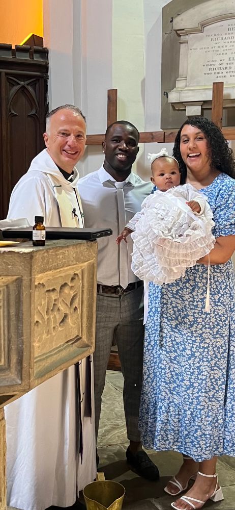 Rev’d Mark stood next to the font with baby Jaida and her parents. 