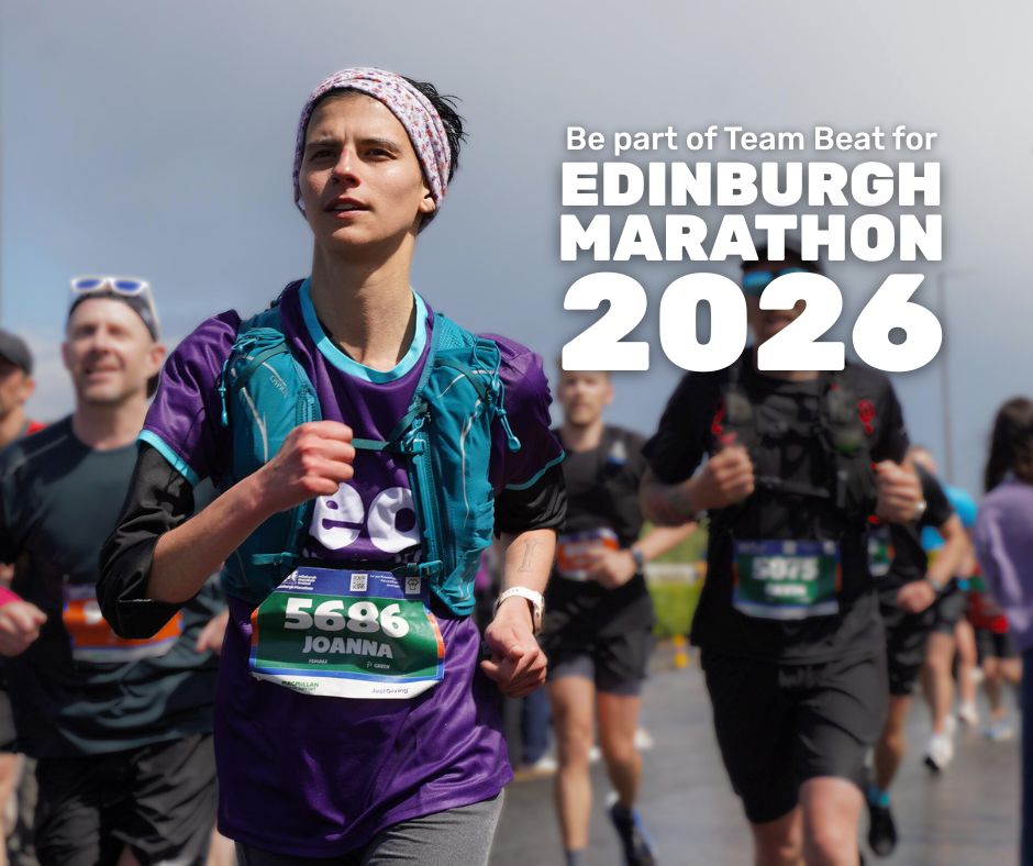 Photo of a young woman mid-stride, running. They are looking past the camera, with a determined yet calm look on their face. They have short dark hair and have a purple patterned headband on. They are wearing a purple Beat-branded t-shirt, with a teal runners vest over the top. Behind them, in the blurred background, are other runners going down the road. Near the top right corner, on the right side of the female runner's head, is white text reading 'Be part of Team Beat for Edinburgh Marathon 2026'.