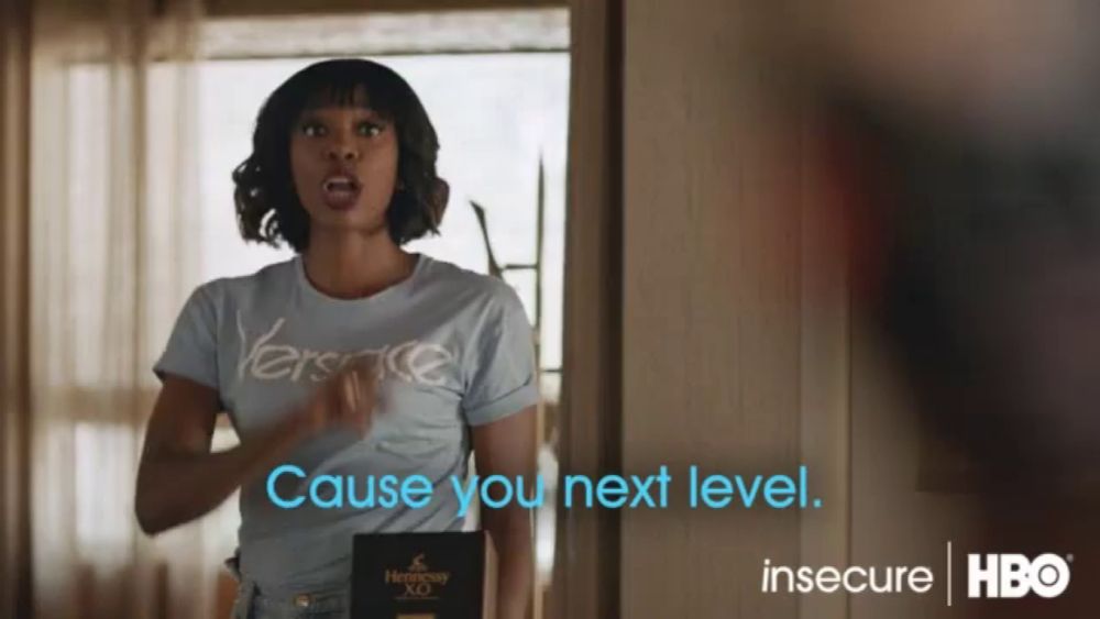 a woman in a versace shirt says " cause you next level " in a hbo ad