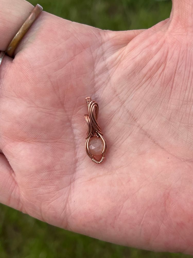 This is a sweet little mini pendant is wrapped in round copper wire with a faceted chocolate silky moonstone