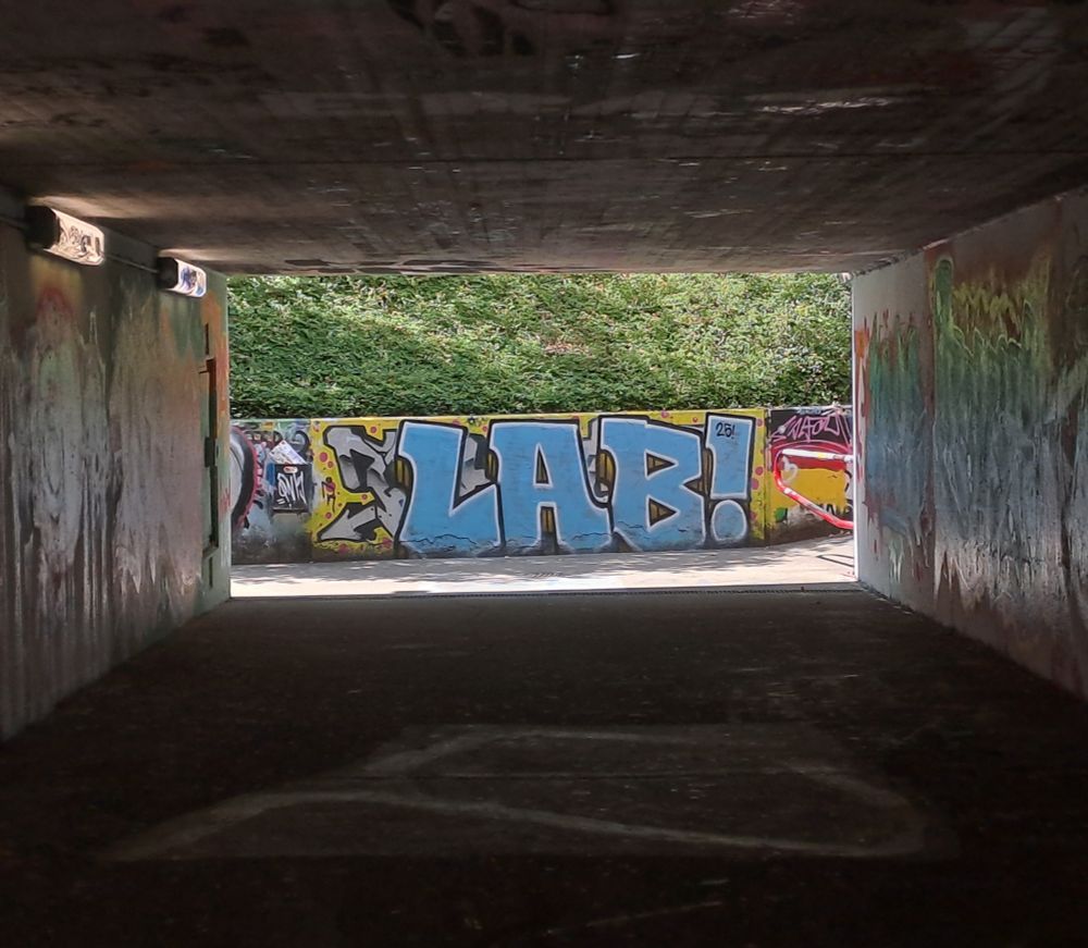 Graffiti at the end of an underpass in Heidelberg saying 'LAB!'.