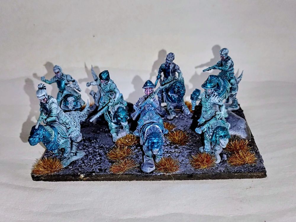 Halfling wild runner cavalry. Metallic green armour, all based onto black sand and rock with tufts 